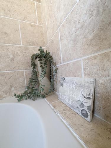 a bathroom with a bath tub with a plant on it at 1 bedroom flat in Gravesend in Kent