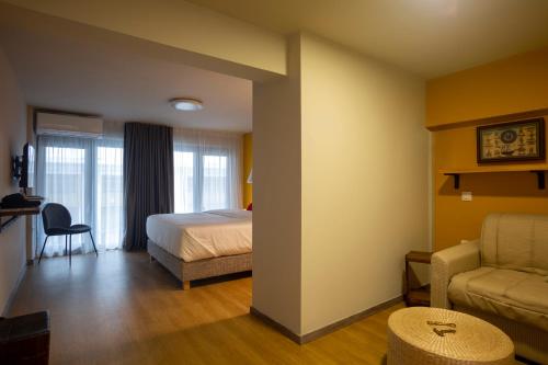a hotel room with a bed and a couch at The Frogs_Guest House in Athens