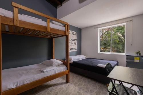 two bunk beds in a room with a table at Living Hotel in Medellín