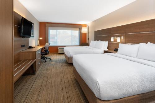 a hotel room with two beds and a television at Holiday Inn Express & Suites Tucson North - Marana, by IHG in Tucson