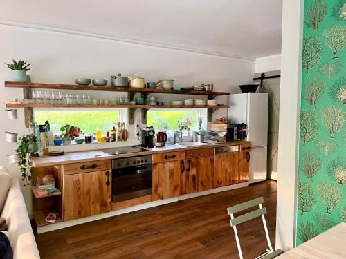a kitchen with wooden cabinets and a sink at Bohemian Eco Lodge at lake Balaton in Kisapáti