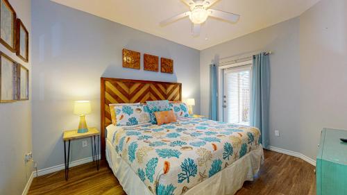 a bedroom with a bed and a ceiling fan at BC604 Roomy Townhome, Outdoor Seating, Shared Heated Pool with Water Slide in Port Aransas
