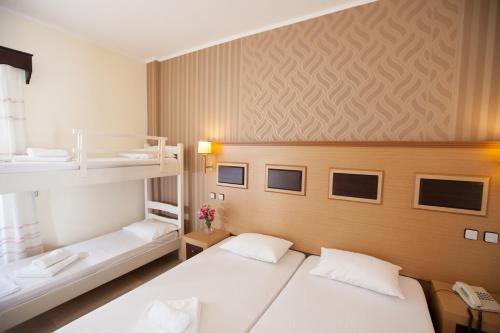 1 Schlafzimmer mit 2 Betten und 1 Etagenbett in der Unterkunft Hotel Kanali in Kanali