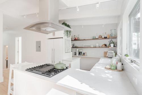 a white kitchen with a stove top oven at STYLISH AND SPACIOUS 2ND Flr 2 BR VICTORIAN HOME in San Francisco