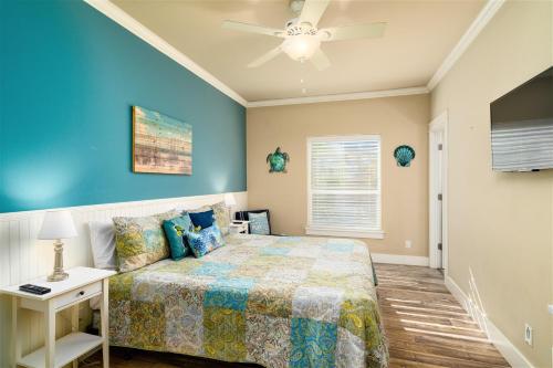 a bedroom with a bed and a ceiling fan at After Dune Delight in Port Aransas