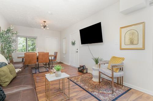 a living room with a couch and a table at Amazing Downtown Views - 3 Minutes to Downtown! in Cincinnati