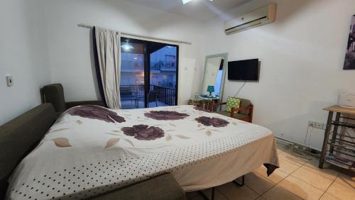 a bedroom with a bed and a window at Ayia Napa Cyprus in Paralimni