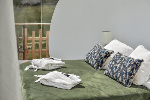 a bed with towels and pillows on it at noct enbulle in Cabrerets