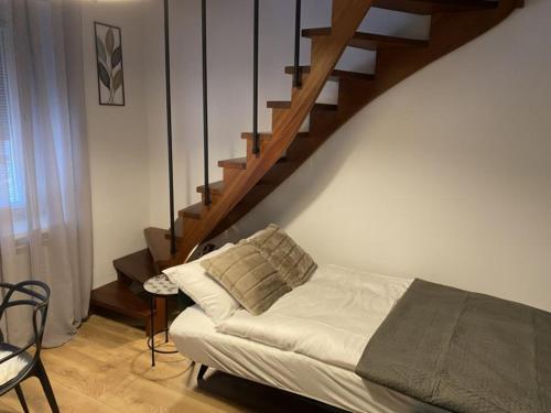 a living room with a bed and a staircase at Apartament Schodami do Nieba in Bytom