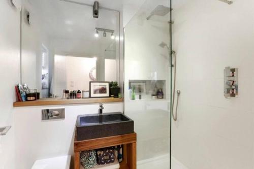 a bathroom with a sink and a shower at Chetwynd Paradise in London