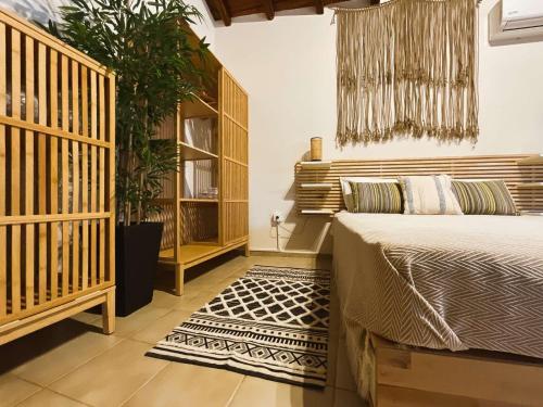 a bedroom with a bed and a potted plant at Spitaki Guest House in Megali Ammos