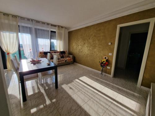 a living room with a table and a couch at Appartamento Divino Tramonto in Altedo