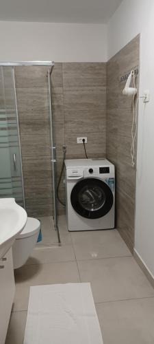a bathroom with a washing machine and a toilet at Holiday Apartment Vrsar in Vrsar