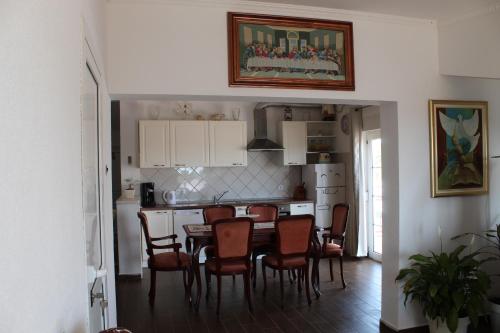 a kitchen and dining room with a table and chairs at Nikola Leko Guest House in Hvar