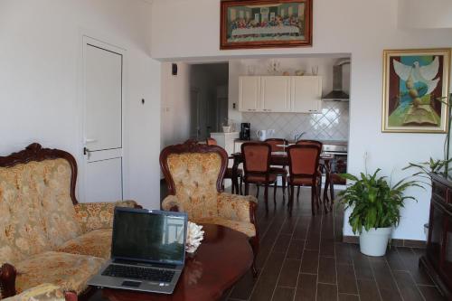 a living room with a laptop sitting on a couch at Nikola Leko Guest House in Hvar
