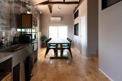 a kitchen with a table in the middle of a room at Etcetera Niijima Jessica Building - Vacation STAY 74384v in Niijimamura