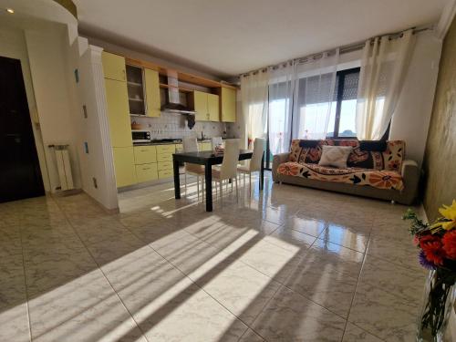 a living room with a couch and a table at Appartamento Divino Tramonto in Altedo