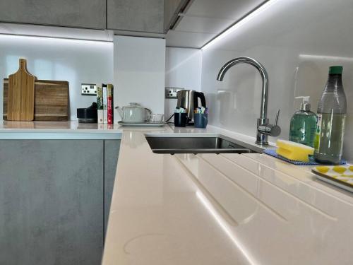 a kitchen with a sink and a counter top at SoHot Stays Ramsgate Stunning Sea View Apt Free Parking in Kent