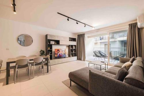 a living room with a couch and a table at The Ultimate Escape in Sliema