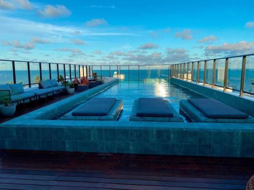 a swimming pool on the roof of a building at Get One in Tambaú