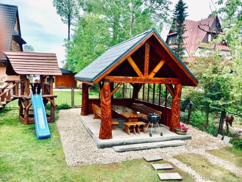 a gazebo with a grill and a playground at Willa Tulula in Kościelisko