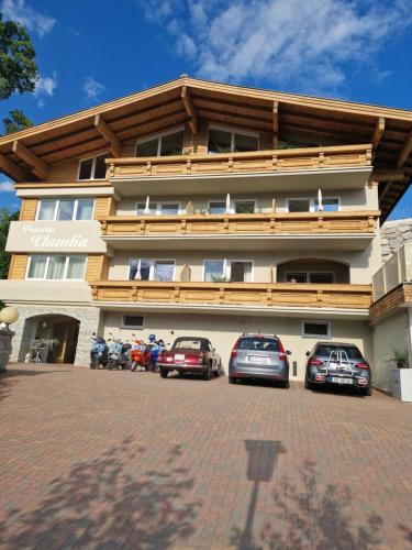 a building with cars parked in front of it at Pension Claudia Zell am See in Zell am See
