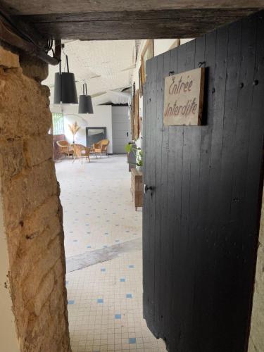 einen Eingang zu einem Gebäude mit einem Schild an der Wand in der Unterkunft Les Chambres de Marc in Fontenille-Saint-Martin-d'Entraigues