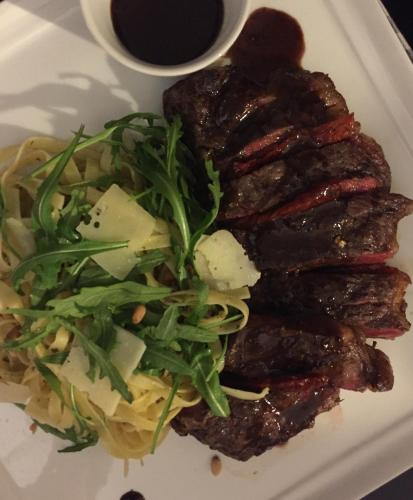 a plate of meat with a salad and a cup of coffee at New Hotel de Lives in Namur