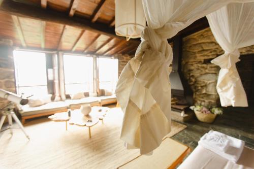 una habitación con una cortina colgando del techo en Apedeceo Belesar Villa, Ribeira Sacra, Galicia, en Chantada