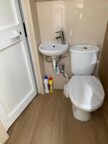 a bathroom with a toilet and a sink at Serenity 2 in Qormi