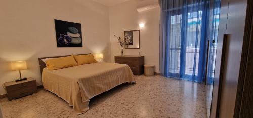 a bedroom with a bed and a large window at La casa di Francesca in Reggio di Calabria