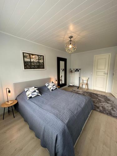 a bedroom with a large bed and a chandelier at Iiris in Imatra