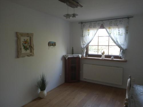 a living room with a window and a wooden floor at Chatka skrzatka in Kruki