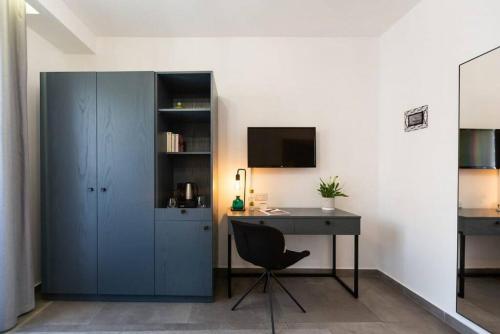 a room with a desk and a cabinet with a computer at The Valley Room 8 condo with parking on premises in St Julian's