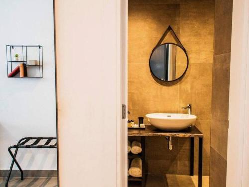 a bathroom with a sink and a mirror on the wall at The Valley Room 8 condo with parking on premises in St Julian's
