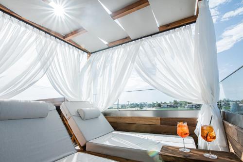a room with a couch and a table and a window at King's & Queen's Afitos - Suites With Private Pool in Afitos