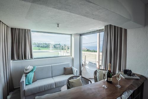 a living room with a couch and a table at King's & Queen's Afitos - Suites With Private Pool in Afitos