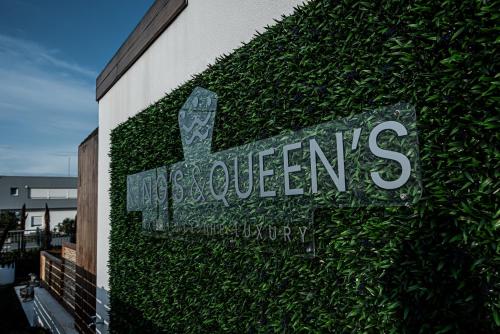 a sign on the side of a building with ivy at King's & Queen's Afitos - Suites With Private Pool in Afitos