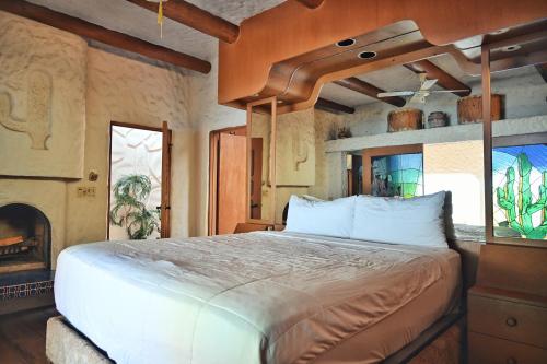 a bedroom with a large bed and a fireplace at Balcones Del Mar in Rosarito