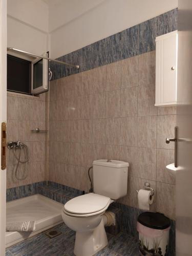 La salle de bains est pourvue de toilettes et d'une baignoire. dans l'établissement Sunset Apartments, à Kanali