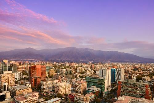a view of a city with mountains in the background at AC Hotel by Marriott Santiago Cenco Costanera in Santiago