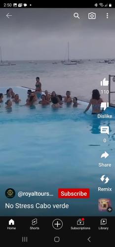 a group of people sitting in a swimming pool at Lovely Apartment In Mindelo City Center in Mindelo