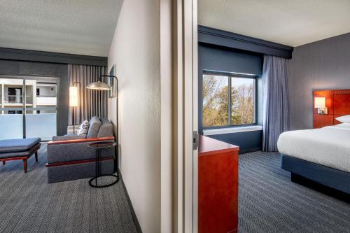 a hotel room with a bed and a desk at Courtyard by Marriott Boston Andover in Andover