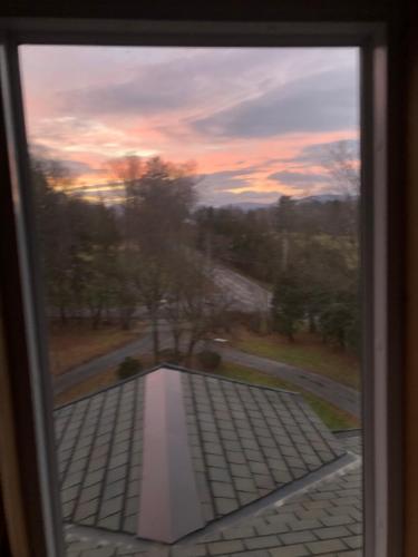 a view out of a window at sunset at Antique Mansion B & B in Rutland