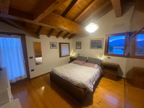 a bedroom with a large bed in a room with wooden floors at Bellavista in Santorso