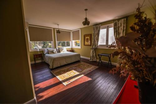 a bedroom with a bed and a large window at Estancia Villa Maria in Ezeiza