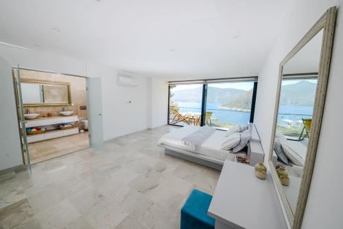 a bedroom with a bed and a large mirror at villa ozma in Kaş