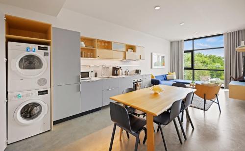 a kitchen and living room with a table and a dining room at Placemakr Wedgewood-Houston in Nashville