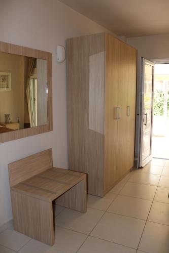 a room with a wooden cabinet and a mirror at Thea Siviri in Siviri