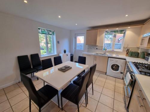 a kitchen with a table and chairs in a kitchen at Bristol House By Cliftonvalley Apartments in Bristol